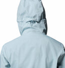 A woman is shown from the back wearing the Columbia Womens Trailborne 2.5L Waterproof Shell Jacket in light blue, set against a white background.
