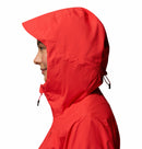 A person in profile wears a Columbia Womens Trailborne 2.5L Waterproof Shell Jacket in bright red, hood up, against a plain white background. This packable rain jacket includes a drawstring at the back of the hood.