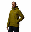 A man in a Columbia Mens Trailborne 2.5L Waterproof Shell Jacket with zippered pockets and black pants stands against a white background, looking confidently at the camera.