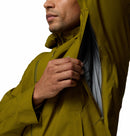 A man in a Columbia Mens Trailborne 2.5L Waterproof Shell Jacket in olive unzips an underarm vent, showing gray mesh lining inside the hiking shell; only his lower face and upper body are visible.