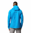 A person wearing a bright blue Columbia Mens Saudan Pro 3L Waterproof Shell Jacket and light gray pants is seen from the back against a plain white background.