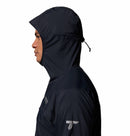 In profile, a person wears the Columbia Mens Khyex Pro™ Wind Jacket in dark color with hood up and tightened. Subtle chest and sleeve logos are visible. The jacket provides UPF 50 protection; the background is plain white.