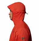 A person in profile faces left against a plain white background, wearing a bright red Columbia Mens Khyex Pro™ Wind Jacket with the hood up. The ultralight jacket offers water and stain resistance and features small chest and sleeve logos.