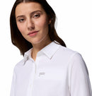 A woman with long brown hair in the Columbia Womens Silver Ridge Utility II Long-Sleeve Shirt stands against a white background, smiling softly. The shirt features UPF 50 sun protection for comfort outdoors.