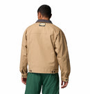 Person wearing a beige jacket with a visible brand logo on the back, standing against a white background.