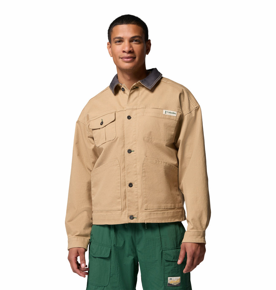 Man wearing a Columbia Acker Rock beige jacket and green pants on a white background