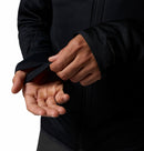 A person wearing the Columbia Mens Summit Step™ Full Zip Technical Fleece demonstrates its thumb hole feature by inserting their thumb through the sleeve opening, highlighting the fleeces lightweight design.