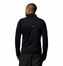 A man with short hair, wearing black pants and a Columbia Mens Summit Step™ Full Zip Technical Fleece jacket, stands facing away from the camera against a plain white background.
