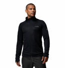 A man stands slightly turned, wearing the Columbia Mens Summit Step™ Full Zip Technical Fleece jacket in black with dark pants, set against a plain white background.