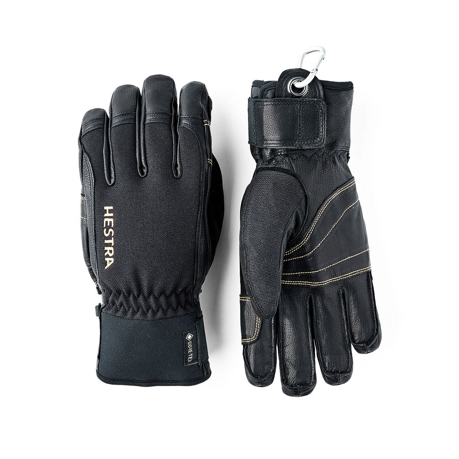 A pair of Hestra Army Leather GORE-TEX Short Gloves in black, featuring visible stitching; one glove is displayed palm up and the other palm down, with a small carabiner clip attached at the wrist.