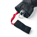 The Hestra Army Leather GORE-TEX Short Glove is a black ski glove featuring a leather strap, silver carabiner, and a red pull tab with printed text designed for easy removal. This waterproof winter glove combines practicality with stylish details.