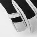 Close-up of the Hestra Army Leather Heli Ski Glove in black and white, highlighting the stitched details and texture of the fabric and leather materials against a plain white background.