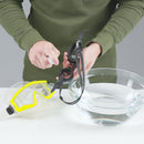 Person cleaning goggles with a cloth on a white surface with water.