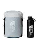 A light gray The North Face stuff sack—ideal for storing the Blue Kazoo Down Sleeping Bag (-7°C)—rests next to a black The North Face water bottle, both featuring the brand’s white logo on a plain white background.