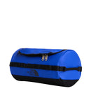 A bright blue cylindrical washbag with black accents and handles, featuring The North Face logo in black on the side and a zippered top flap—an excellent choice for those seeking durable travel accessories; this is the Base Camp Travel Washbag - Large by The North Face.
