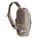 A beige Borealis Sling Bag by The North Face, crafted from recycled nylon, showcases a single padded strap, multiple compartments, and a side buckle—delivering the versatile functionality of a compact sling bag against a white background.