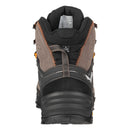 Rear view of a Salewa Men’s Alp Trainer 2 Mid GORE-TEX Hiking Boot featuring brown and black panels, orange stitching, a rugged mountain-ready sole, and a tongue label displaying size and material details.
