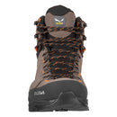 A front view of the men’s Salewa Alp Trainer 2 Mid GORE-TEX hiking boot in brown and black, accented with orange laces. Engineered with waterproof GORE-TEX protection, this rugged hiking boot features a reinforced toe, durable tread for mountain terrain, and Salewa branding on the tongue and sole.