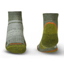 Two green socks with patterned design on a white background