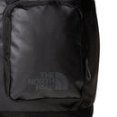 Close-up of the Base Camp Voyager Tote Bag by The North Face, crafted from recycled durable fabric in black, featuring a front zippered pocket with the gray The North Face logo positioned on the pocket.