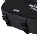 Close-up of The North Face Terra 6-Litre Bum Bag in black, showing part of the logo. Two plastic buckles and straps are attached to the lower section, emphasizing its practicality for carrying hiking essentials.