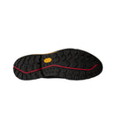The image displays the black rubber Vibram outsole of The North Face Men’s Verto GORE-TEX Alpine Shoes, featuring rugged tread patterns, a red wavy line running through the center, and a yellow Vibram logo near the arch. This detail underscores the exceptional durability and grip these waterproof hiking shoes provide for challenging alpine trails.