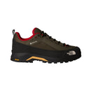 A single Men’s Verto GORE-TEX Alpine Shoe by The North Face, shown from the left, featuring an olive green and black design with red accents, black laces, a Vibram outsole, and The North Face logo on the side; engineered as waterproof hiking footwear for dependable trail performance.