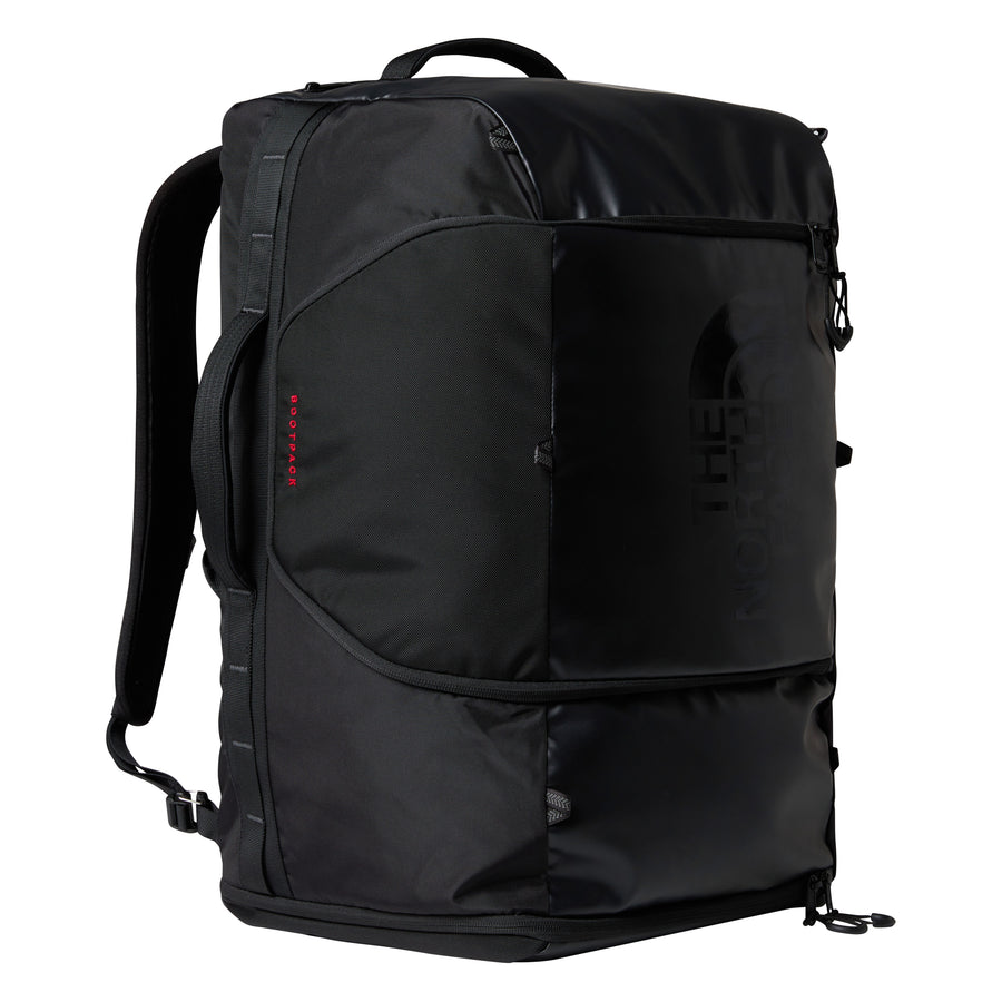 A black Great Outdoors Base Camp Boot Bag with padded straps, multiple compartments, and a sleek, durable design—perfect for carrying your snowboarding boots. The logo appears subtly on the front, and the bag stands upright against a white background.