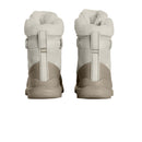 A pair of The North Face Womens ThermoBall Leather Waterproof Boots in beige, featuring thick, fluffy white lining, viewed from the back to display their textured soles and fabric pull loops.