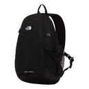 A black The North Face Hot Shot Sling Bag featuring a front zip pocket, side mesh pocket, top handle, and adjustable shoulder straps. Inspired by the versatility of a modular sling bag, HOT SHOT is printed on the bottom front.