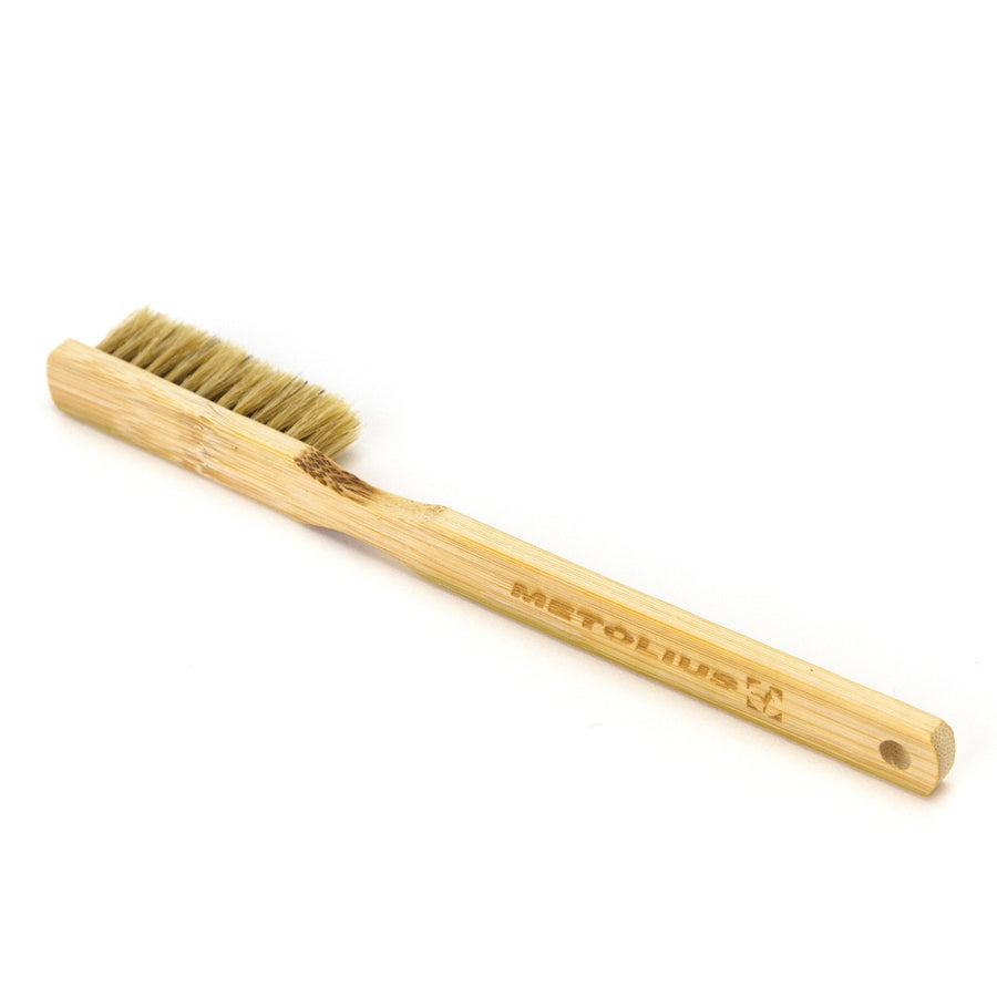 Bamboo bouldering brush with bristles on a white background