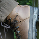 Meindl Bhutan MFS leather hiking boot heel on a wooden pole with green hiking pants.