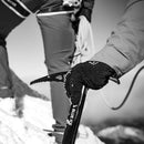 Person holding an ice axe with a blurred background