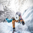 Person ice climbing in a snowy mountain setting