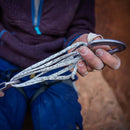 Person holding a slings attached to a carabiner with a blurred background