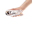 A hand holding a tightly rolled bundle of white cords or straps with small orange and black details, isolated on a white background.