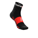 A Compressport Unisex Training Sock from a 2 Pack, in black and red with arch support, white cuff text, and red grip dots on the sole, is displayed on a white background.