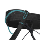 Close-up of a black and teal climbing harness with a buckle on a white background