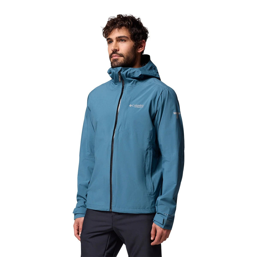 Man wearing a blue jacket with a brand logo on a white background