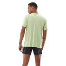 Person wearing a light green athletic shirt and black shorts on a white background