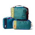 Set of three colorful packing cubes with Cotopaxi branding on a white background