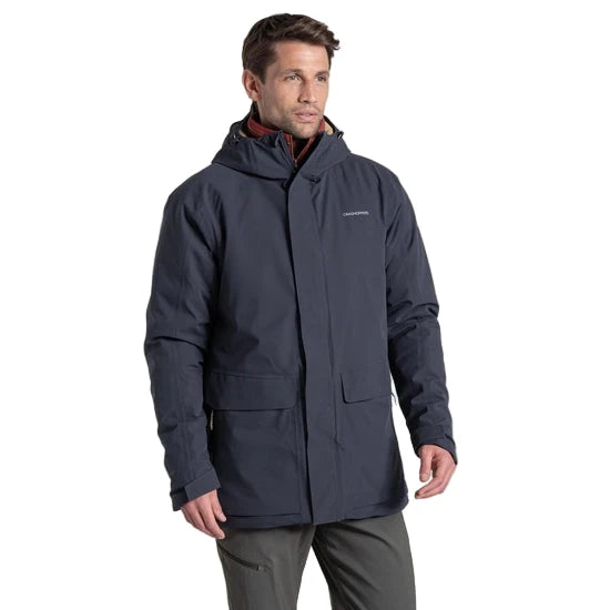 Man wearing a dark blue jacket with a hood on a white background