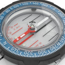 Close-up of a compass with blue and white markings on a gray background