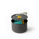 The Sea to Summit Frontier Ultralight One Pot Cook Set 2L (5-Piece) is a gray ceramic non-stick camping pot with a lid and foldable metal handle, shown partially open to reveal a teal and yellow cup and bowl nested inside. This ultralight camp cook set features convenient measurement markings on the side, making it perfect for any nesting camp kitchen setup.