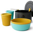 The Sea to Summit Frontier Ultralight One Pot Cook Set 2L (5-Piece) features a large black ceramic non-stick camping pot with lid, accompanied by a yellow-and-blue bowl, a yellow cup, and a blue cup—all designed with ribbed exteriors and coordinating lids. The intelligent nesting design keeps the entire camp kitchen set compact for efficient storage during your outdoor adventures.