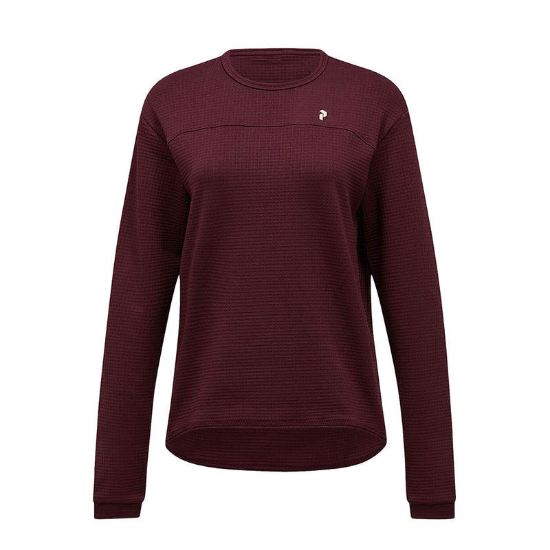 A womens Trail Polartec Power Grid Crew Fleece by Peak Performance, featuring long sleeves, a maroon textured fabric, and a small white logo on the left chest, displayed against a plain white background.