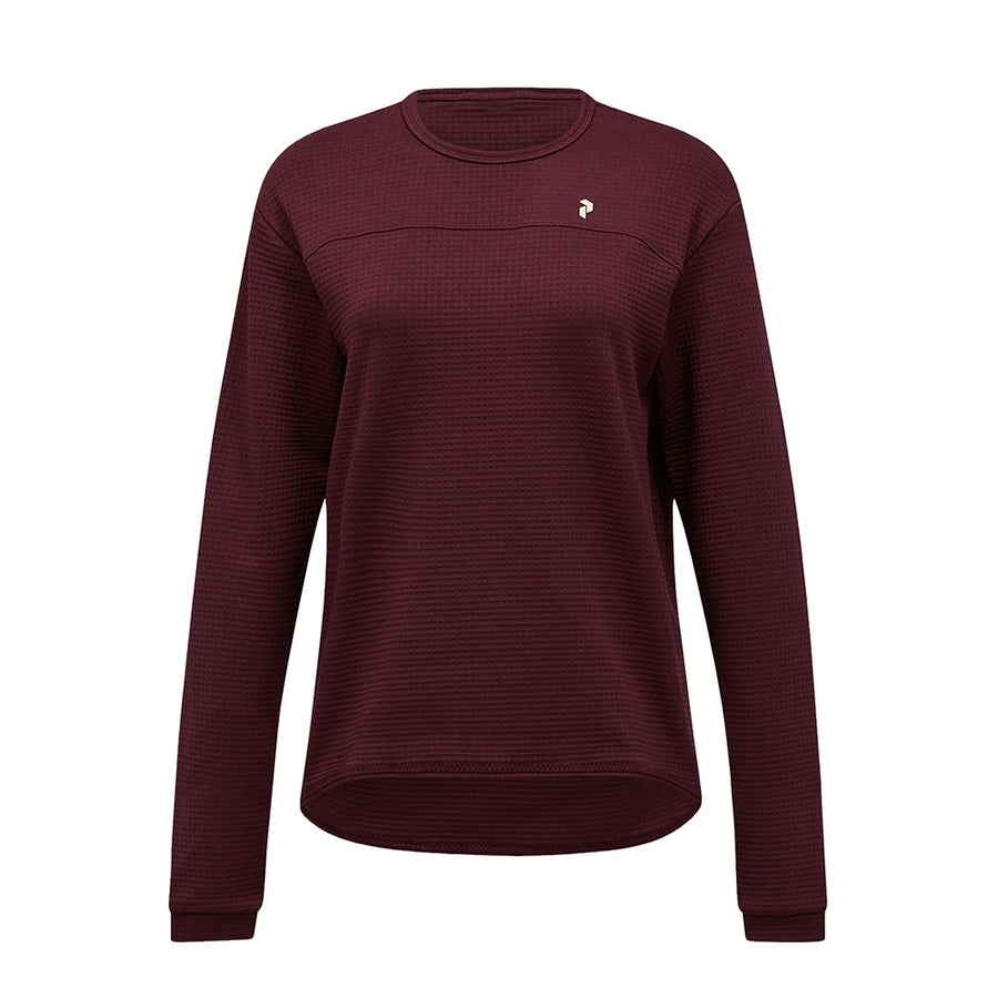 A womens Trail Polartec Power Grid Crew Fleece by Peak Performance, featuring long sleeves, a maroon textured fabric, and a small white logo on the left chest, displayed against a plain white background.