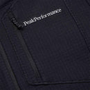 Close-up of the Mens Trail Polartec Power Grid Half Zip Fleece by Peak Performance, featuring a black fabric pocket with a zipper and an embroidered white Peak Performance logo above it, highlighting the technical midlayer design crafted from advanced Polartec Power Grid fabric.