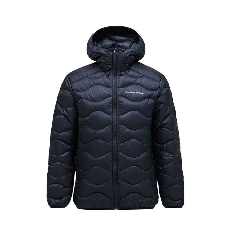 The Mens Helium Down Hooded Jacket by Peak Performance features a black, ultralight, and packable design with a front zipper and subtle wave-like stitching. A small logo on the left chest adds a stylish touch, making this jacket an ideal choice for those seeking comfort and contemporary flair.