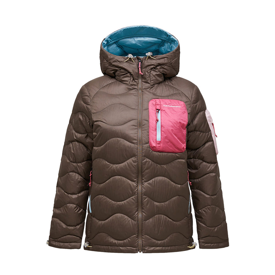 Introducing the Womens Helium Utility Down Hood Jacket by Peak Performance—a brown quilted, packable jacket designed for women. It features a blue-lined hood, a pink chest pocket, and stylish pink accents along the right sleeve and sides. Crafted with an ultralight down fill and distinctive wave-inspired quilting, this jacket ensures warmth without weight. The front zipper closure complements its windproof and water-repellent construction, making it an ideal choice for versatile weather protection.